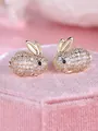 Close-up of cute rabbit stud earrings fully paved with sparkling clear crystals - Champagne Gold White Stone