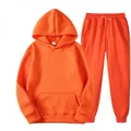 Detailed view of bright orange men's tracksuit set with hoodie and sweatpants. - S / Top And Bottom / Orange Red