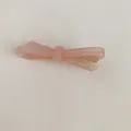 Vue détaillée d'une élégante pince à cheveux en acétate rose avec texte fait main - Rose