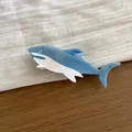 Macro detail of a creative blue and white shark-shaped acetate hair claw clip on linen - Blue Shark
