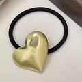 Detail view of golden heart-shaped alloy charm on minimalist black elastic hair tie - Single Hollow Heart - Gold (11#Hollow-Heart-Gold)