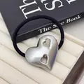 Macro view of metallic heart pendant on a premium minimalist black elastic hair tie. - Double Hollow Heart - Silver (14#Double-Hollow-Heart-Silver)