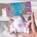 Handheld detail of a white plush pig squishy toy for stress relief in pixel-style packaging - Small Lucky Pig (White)