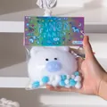 Cute white plush pig squishy toy with colorful pixel art packaging held in hand - Large Lucky Pig (White Type 2)