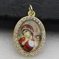 Detailed close-up of an oval religious icon pendant with a micro-pave rhinestone frame - Gold Classic Religious Icon Style (DZJFT001) / Gold Red Variant 6