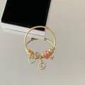 Elegant gold stainless steel charm bracelet with pink stones and heart pendants. - Heart Circle