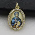 Detailed macro shot of an oval religious pendant with gold-tone rhinestone frame. - Gold Saint Portrait Style (DZJFT001) / Gold Blue