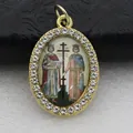 Close-up detail of an oval golden pendant featuring micro-pave rhinestones and religious icon - Gold Religious Illustration Style (DZJFT001) / Gold Floral