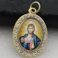 Macro view of a gold-plated oval pendant with inlaid crystals and religious icon. - Gold Jesus Christ Style (DZJFT001) / Gold Blue Variant 3