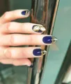 Handmade deep blue almond press-on nails with intricate gold metallic floral patterns - Royal Blue Gilded French