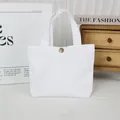 Minimalist solid white canvas tote bag featuring a vintage bronze snap button detail - 8oz Snap Button Style / White