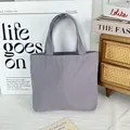 Detailed view of a minimalist purple canvas tote bag in a lifestyle setting - 8oz Open Style / Gray