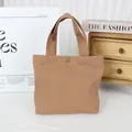 Minimalist solid color canvas tote bag presented in an aesthetic lifestyle home setting - 8oz Snap Button Style / Brown