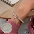 Unique textured silver coiled bracelet with vintage OT buckle closure shown on wrist - Coil Wrapped OT Buckle Bracelet (SL3688)