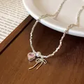 Elegant silver beaded necklace featuring a pink heart zircon, pearl and bow charm detail - Necklace / Silver
