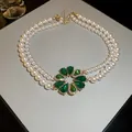 Elegant double-strand pearl necklace featuring a vibrant green zircon flower pendant - Necklace / Green