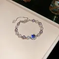 Elegant 18k gold plated bracelet with purple and white pearls and blue zircon charm - Bracelet / Silver