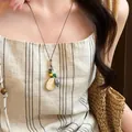 Vintage wood resin geometric oval pendant necklace worn with a linen striped dress - Geometric Oval Maillard Style (25#)