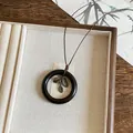 Retro Maillard style necklace with dark wooden circular pendant and metallic leaf charms - Hollow Circle Leaf Style (29#)