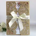 Elegant laser cut wedding invitation card with cream satin bow and floral insert. - Beige Gold