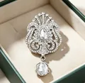 Elegant silver crown brooch with sparkling water-drop rhinestones in green jewelry box. - Crown Waterdrop Shape / Silver