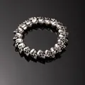Vintage gothic punk style silver skull bead bracelet for men on a black surface - 20 Skulls Silver (L274-1)