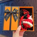 Elegant handmade red crochet flower bouquet keychain presented in a luxury orange gift box - Creative Red Rose (Orange Gift Box)
