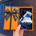 Handmade crochet flower bouquet keychain charm presented in a luxury orange gift box - Creative Blue Rose (Orange Gift Box)
