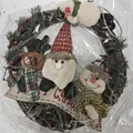 Christmas vine wreath featuring plush Santa and snowman decorations - Old Style Santa Snowman & Reindeer Wreath