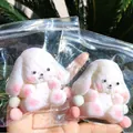 Soft white plush animal squishy toy in clear ziplock packaging - Long-eared Dog