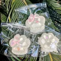 Set of three white translucent cat paw squishy toys with decorative pink bows and stars - White Moonlight Cat Paw