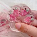 Clear flower-shaped squishy toy with pink floral inclusions for effective stress relief - Strawberry Cat Paw