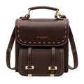Classic vintage dark brown leather backpack featuring white stitching and elegant gold hardware - Coffee