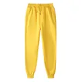 Bright yellow fleece-lined joggers featuring a drawstring waist and ribbed ankle cuffs - S / Bottoms / Bright Yellow