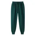 Dark green solid color fleece joggers featuring drawstring waist and elastic cuffs - S / Bottoms / Dark Green