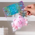 Cute pink plush pig squishy stress relief toy presented in colorful pixel art packaging - Small Lucky Pig (Pink)