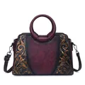 Vintage burgundy crossbody handbag with embossed floral patterns and round handles - Burgundy