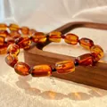 Detailed close-up showing the rich texture of a vintage natural amber honey wax bracelet - Amber Beeswax Bracelet (831910954879)