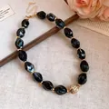 Vintage black marble acrylic bead necklace with gold spacers on a textured background. - 62# Necklace / Black