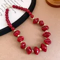 Close-up of a chunky red acrylic beaded necklace with elegant golden spacer beads - 65# Necklace / Red