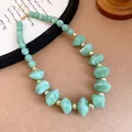 Detail of light green acrylic beaded necklace with marble pattern and gold spacers. - 67# Necklace / Green