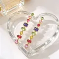 Close-up of elegant long dangle earrings with vibrant multi-colored crystal candy stones. - Multicolor Long Drop Earrings (WG-1433) / Light gold