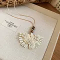Macro view of woven fan-shaped pendant with delicate flower accents - Style 2# (Fan Skirt Style) / Beige