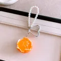 Close-up of realistic orange pendant with white pearl bead strap and heart clasp. - Peeled Orange Charm (Silver Clasp) / Orange
