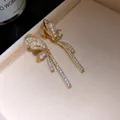 Detailed view of elegant 18k gold butterfly clip-on earrings with pearls and shiny zircons - Butterfly Style (HE34292) / Gold