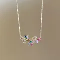 Close-up of a vibrant colorful cubic zirconia floral pendant necklace on a gold-tone chain. - Necklace / Gold-Multicolor