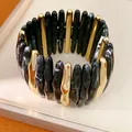 Detailed view of acrylic marble and gold-tone elastic bracelet with smooth texture - Black