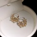 Detailed macro view of French vintage hollow basket earrings with inlaid pearls and crystals. - Pearl Flower Basket (HE34468) / Gold