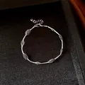 Detailed view of silver mesh bracelet with colorful candy beads on textured black background - Bracelet-Purple