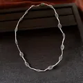 Detail view of silver wire mesh necklace with green crystal beads on black display tray - Necklace - Silver - Green
